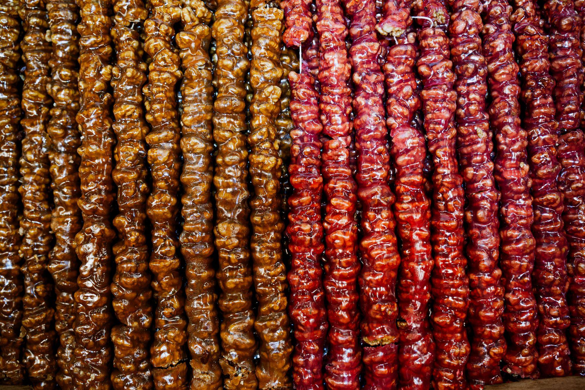 Rows of glossy churchkhela made from grape must and walnuts