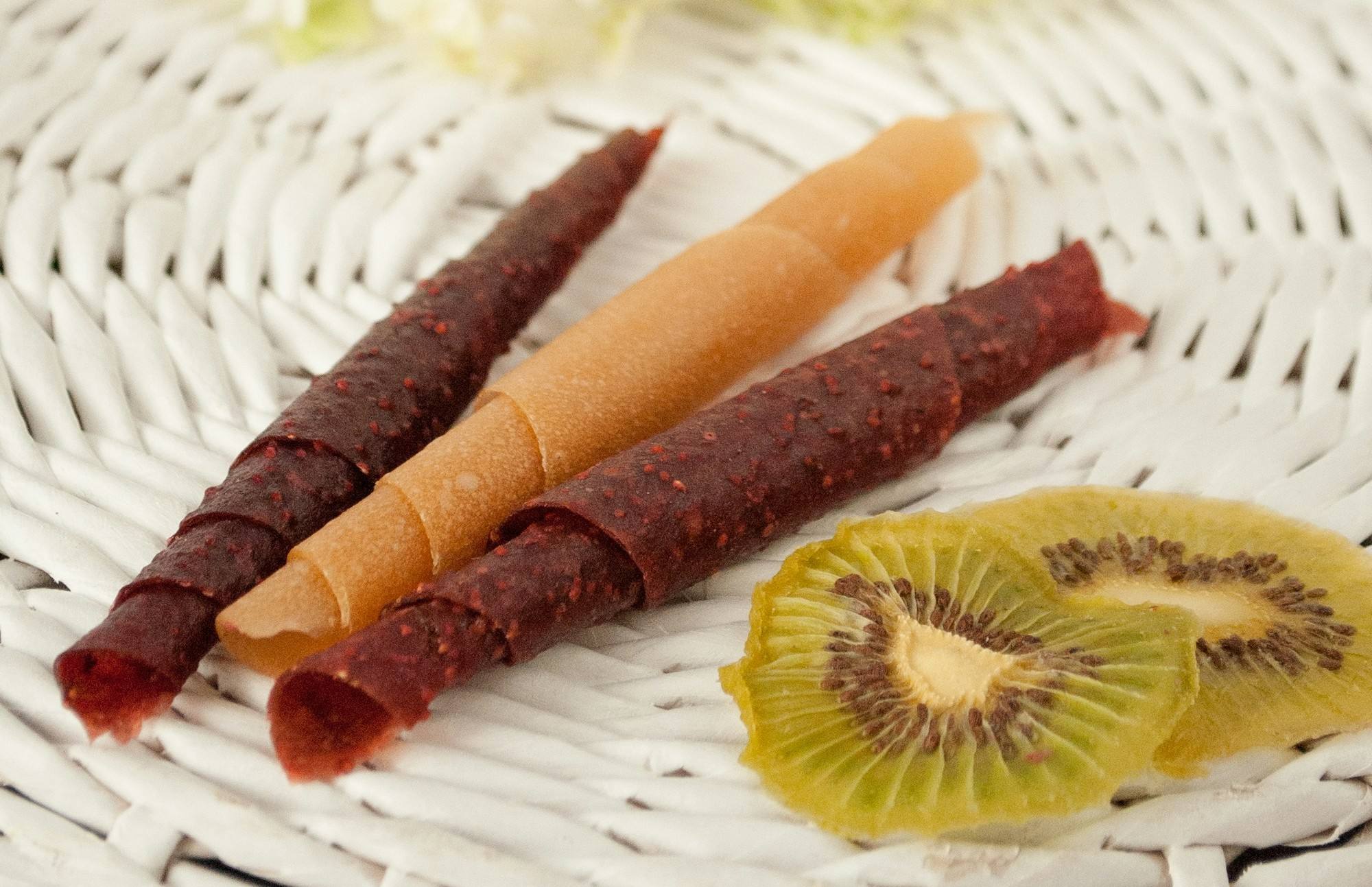 Rolled fruit leather in plum red and apricot